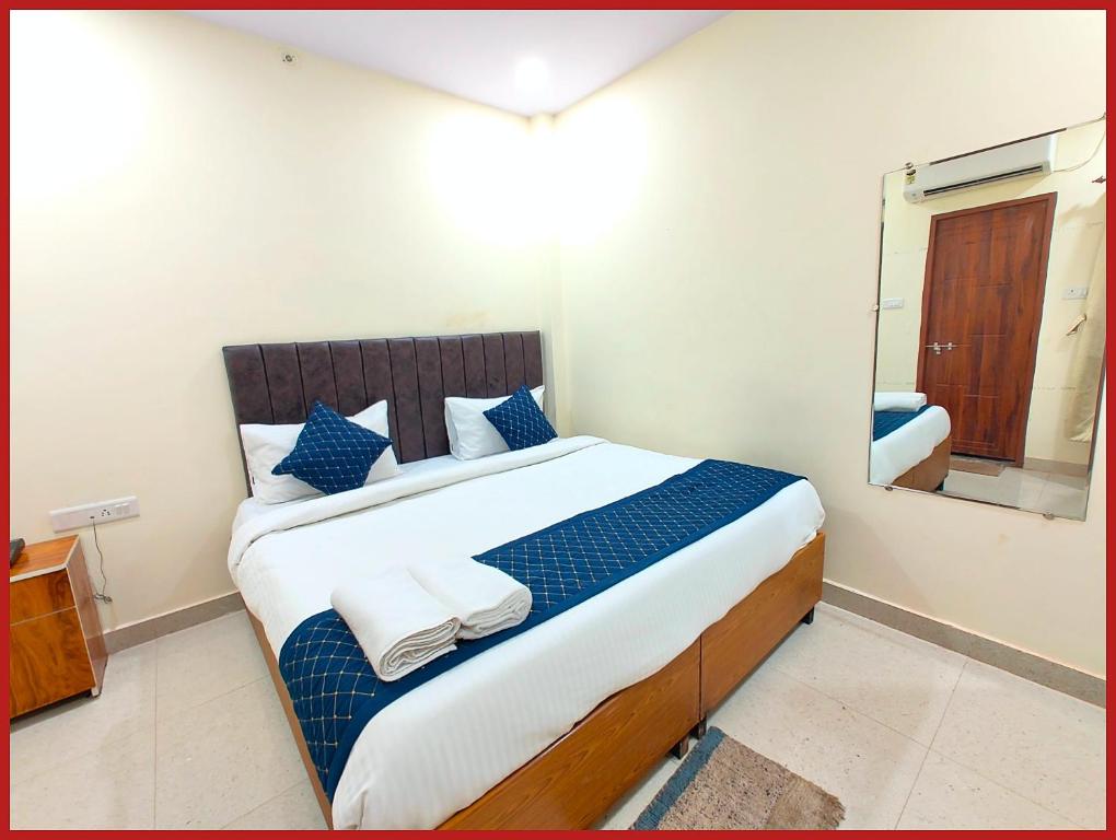 a bedroom with a large bed with a mirror at Hotel New Kashi - Grand Near Vishwanath Temple - Fully Air Conditioned Rooms - #Restaurant #Wi-fi #Lift # Parking Facilities - A Top Rated Hotel in Varanasi