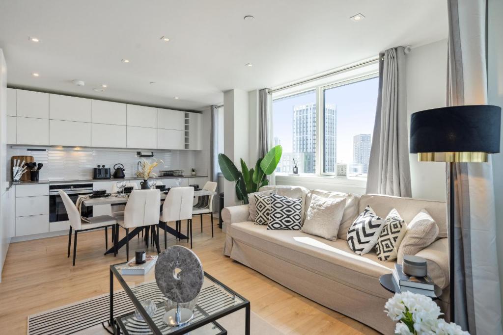 a living room with a couch and a table at Luxury 3-Bed Apt in Wembley Park in London