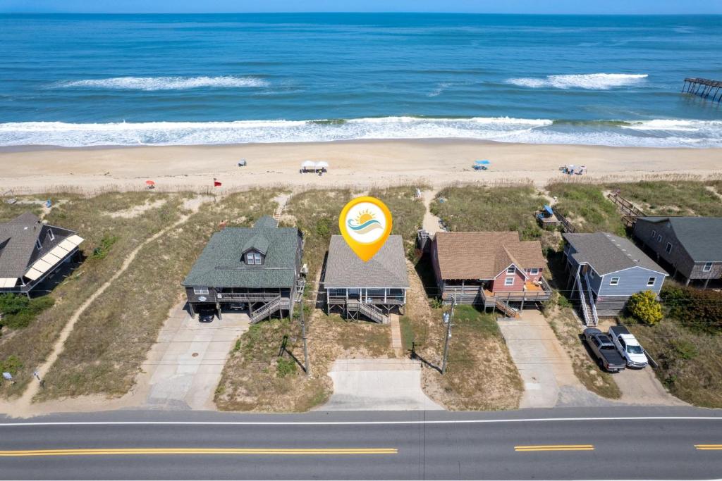 an aerial view of a house with a beach at 5050 - Sea Haven in Kill Devil Hills