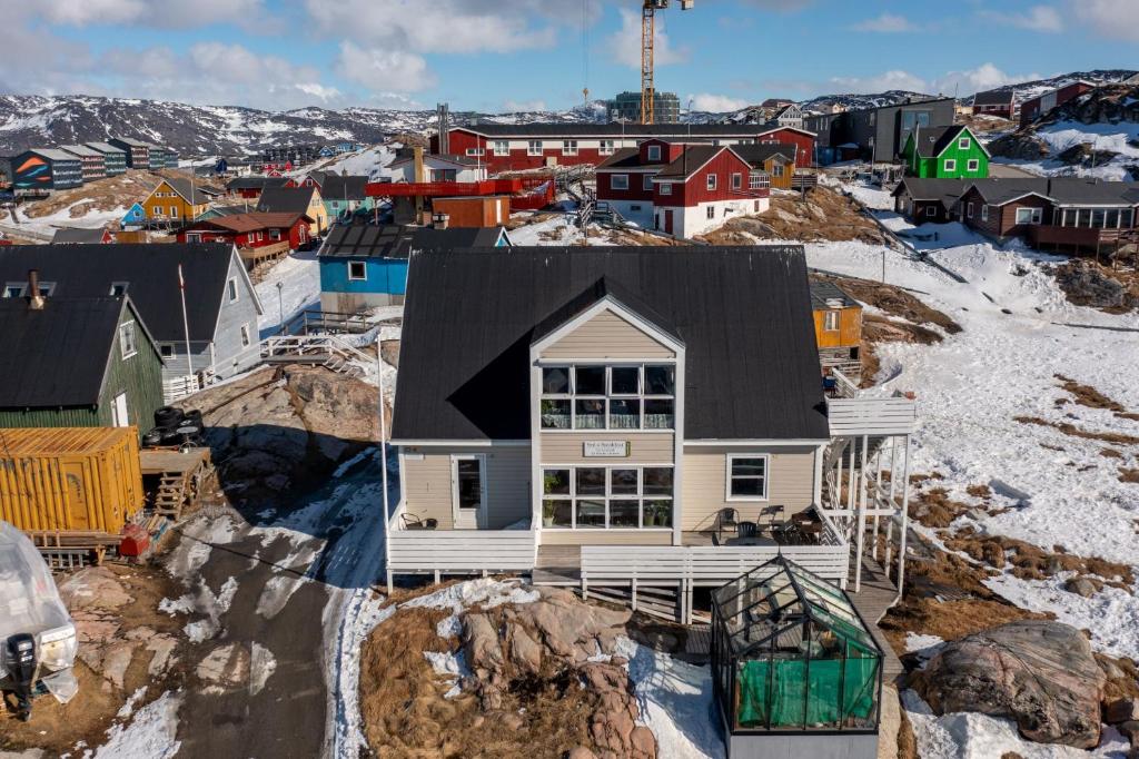a house on top of a hill with snow at Ilulissat Stay - Nanna's Villa - 1 in Ilulissat