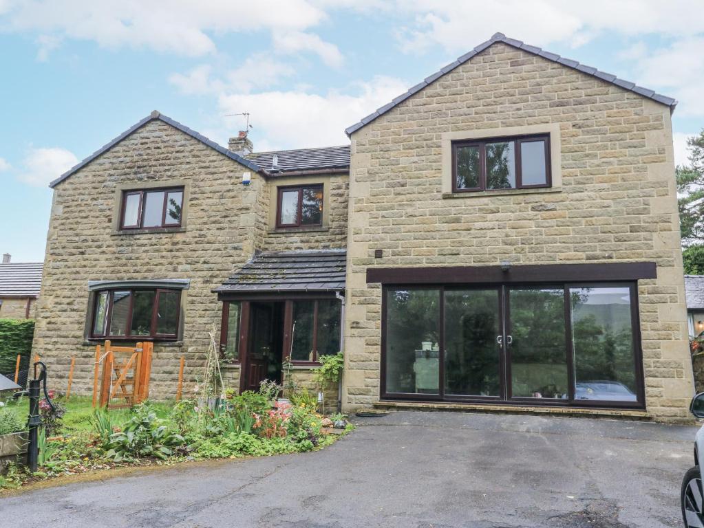 a brick house with large glass windows at The Treetop in Settle