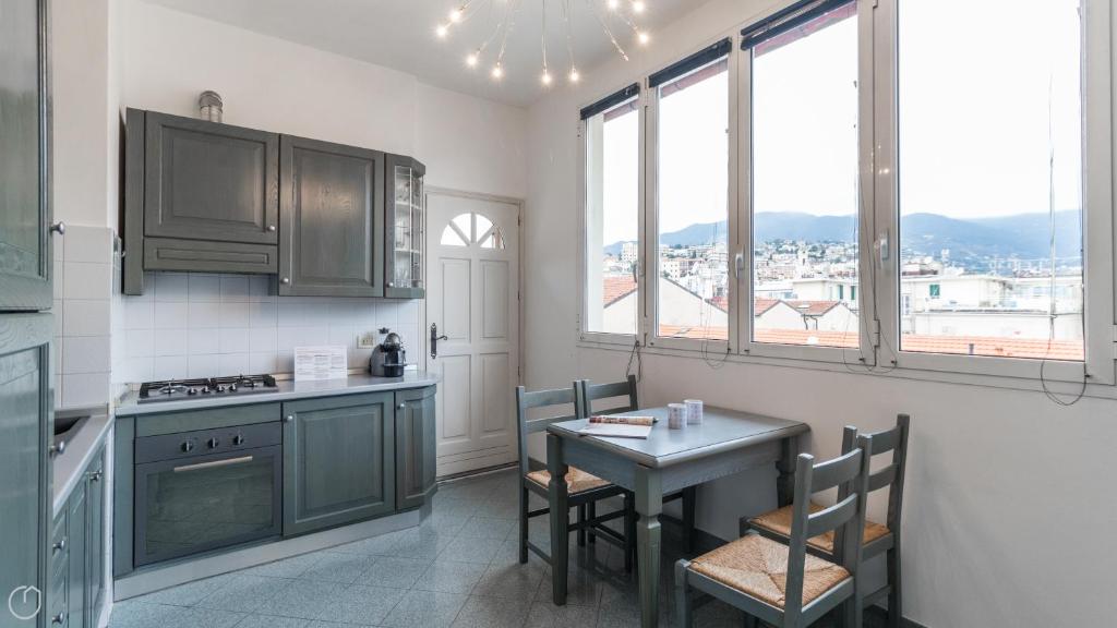 a kitchen with a table and a small table and chairs at Italianway - Roma 70 in Sanremo