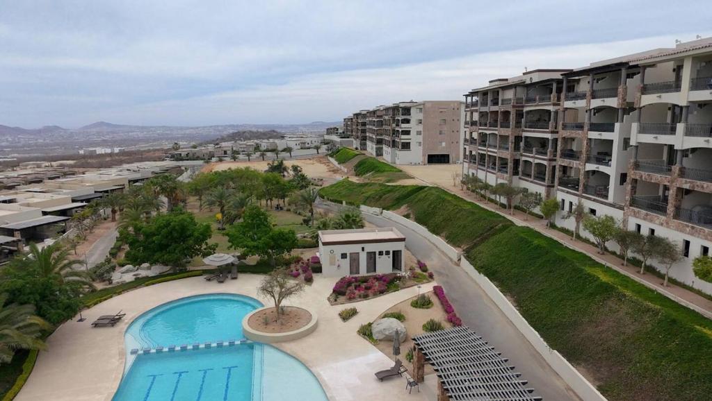 an aerial view of an apartment complex with a swimming pool at Condo Ventanas El Arco Views & Pool in Cabo San Lucas