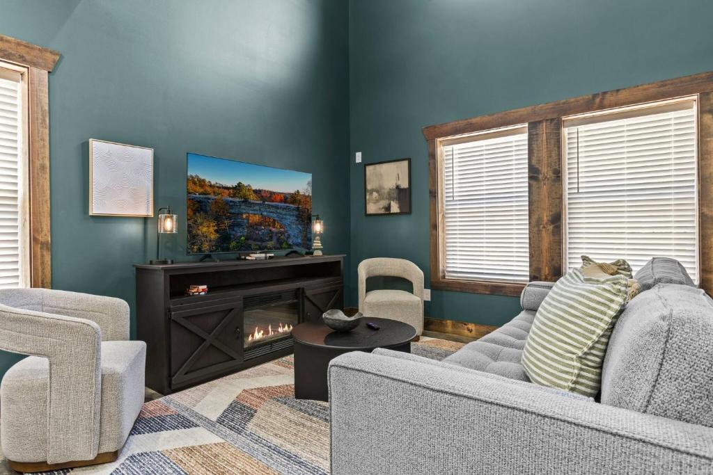 a living room with a couch and a fire place at Sleeps 24/ 4 Kitchens / 4 Hot Tubs / 4 Firepits in Slade