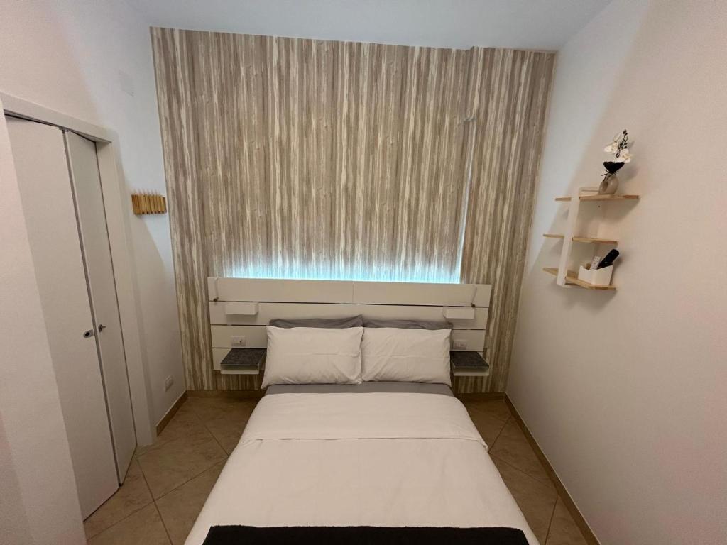 a small room with a bed in front of a window at Vittoria Mini Apartment in Campobasso