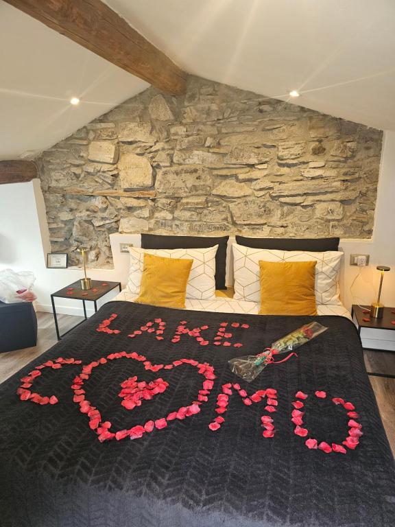 a bed with the word love written on it at Luxury Room La Terrazza sul Lago di Como in Blevio