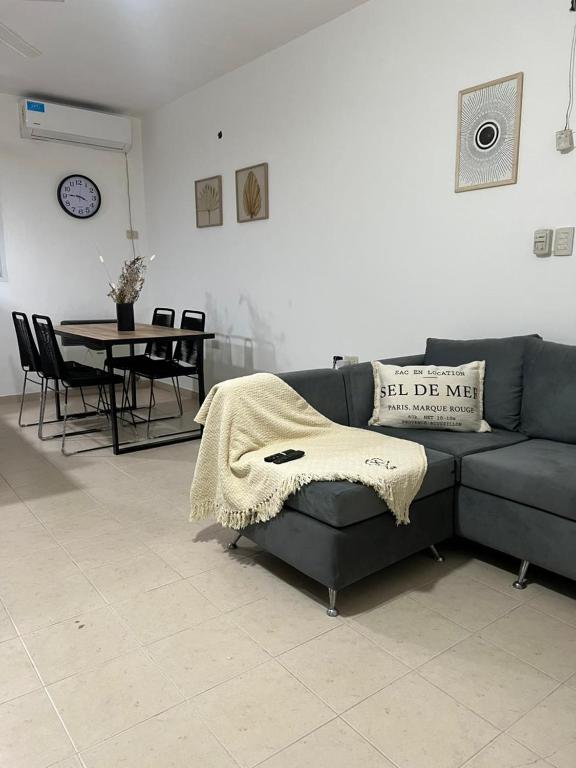 a living room with a blue couch and a table at Departamento campitelli in Santiago del Estero