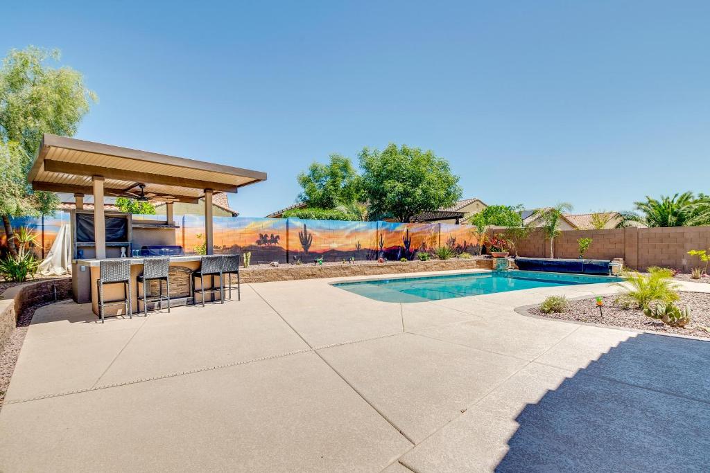 a patio with a table and chairs next to a pool at San Tan Valley Vacation Rental with Community Perks! in San Tan Valley