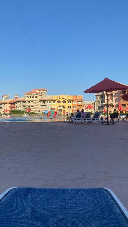 a view of a beach with cars and an umbrella at Porto sharm in Sharm El Sheikh