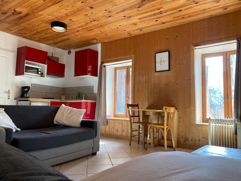 a living room with a couch and a table at Studio Serre Chevalier Briancon in Briançon