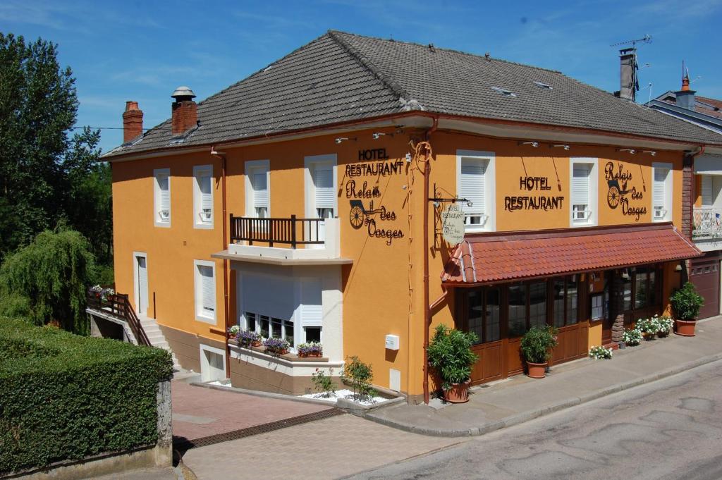 ein Gebäude, das seitlich geschrieben ist in der Unterkunft Hôtel Relais des Vosges in Monthureux-sur-Saône