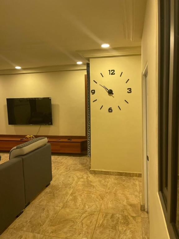 a large clock on a wall in a living room at W&J Luxury Home Plaza in Trofwi