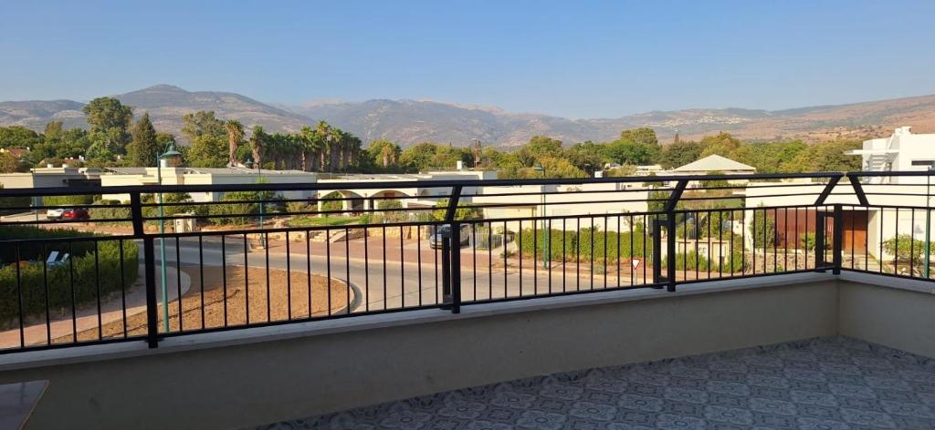 a balcony with a fence with a view of a field at Mountain view in Dafna in Metsudat Menahem Ussishkin Alef
