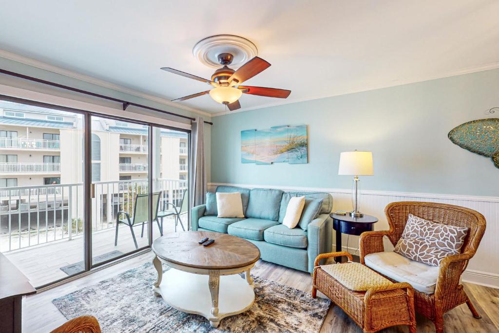 a living room with a couch and a table at Romar Beach 205 in Gulf Shores
