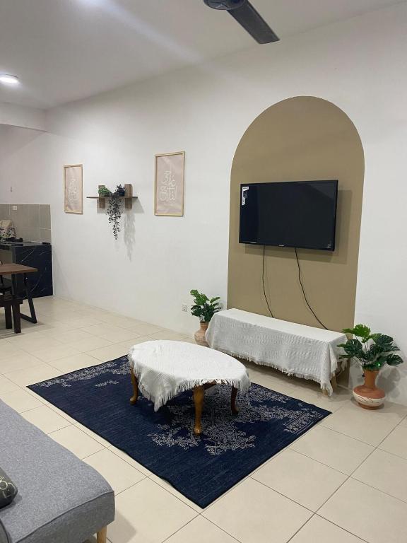 a living room with a flat screen tv on a wall at Homestay TigaCahaya in Seremban