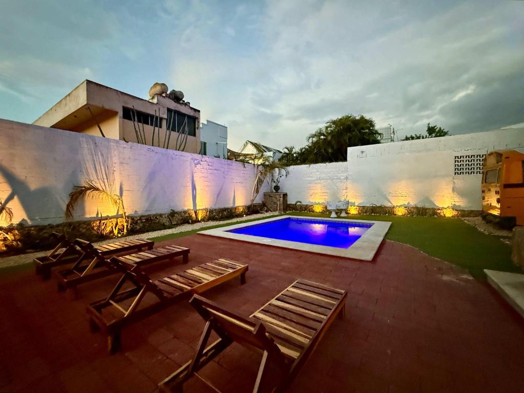 un patio con sedie a sdraio e una piscina di Bright Studio with Shared Pool Access a Mérida