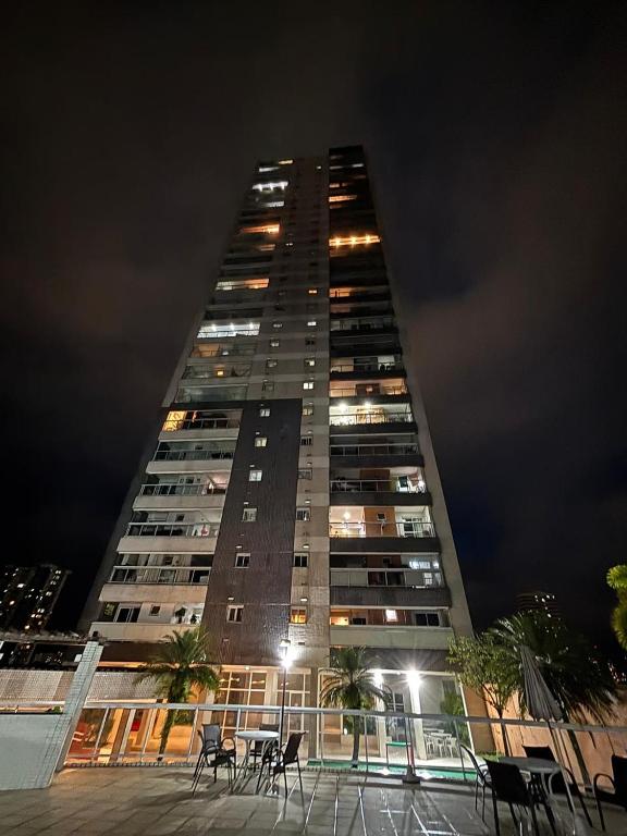 a tall building with tables and chairs in front of it at TORRE SOLAZZO - Cop 30 in Belém