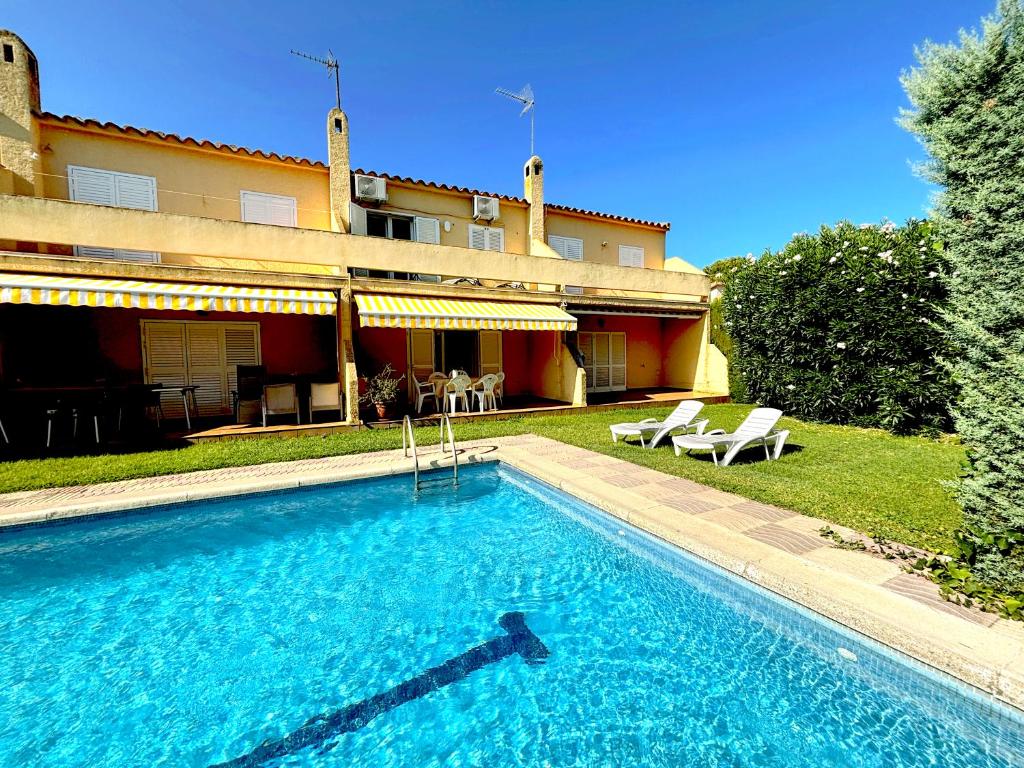 a large swimming pool in front of a house at Ca L'Anxoveta - casa amb piscina a prop de la platja a l'escala in L'Escala