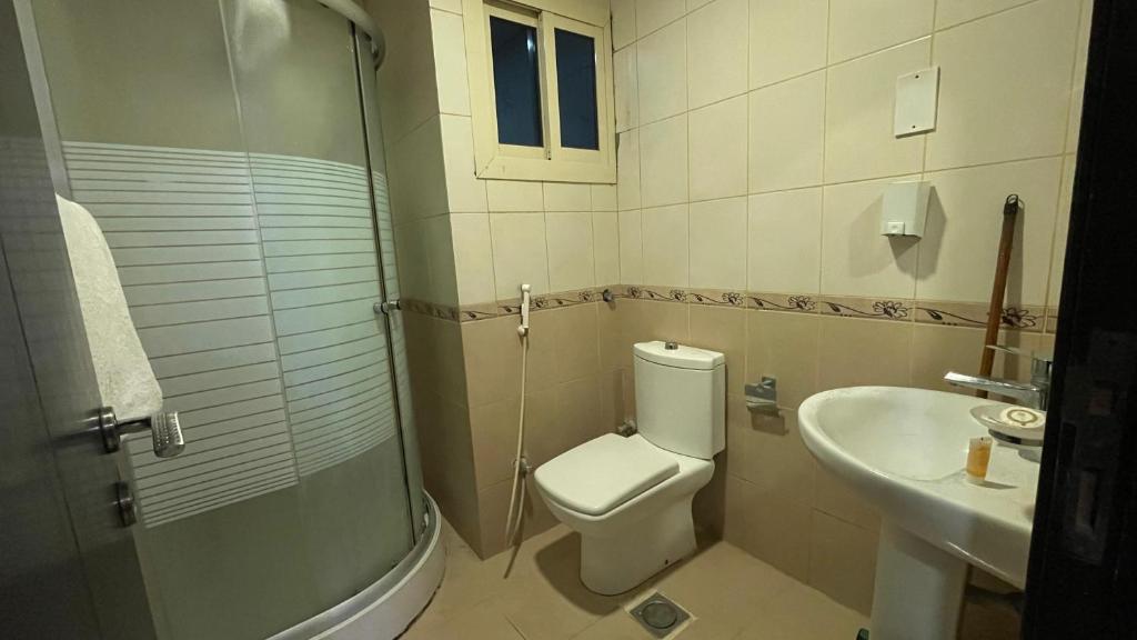 a bathroom with a toilet and a sink at فندق الأصالة البكية توصيل مجاني الى الحرم - ALAsalah ALBakkiya Hotel Free Shuttel Service in Al Masfalah