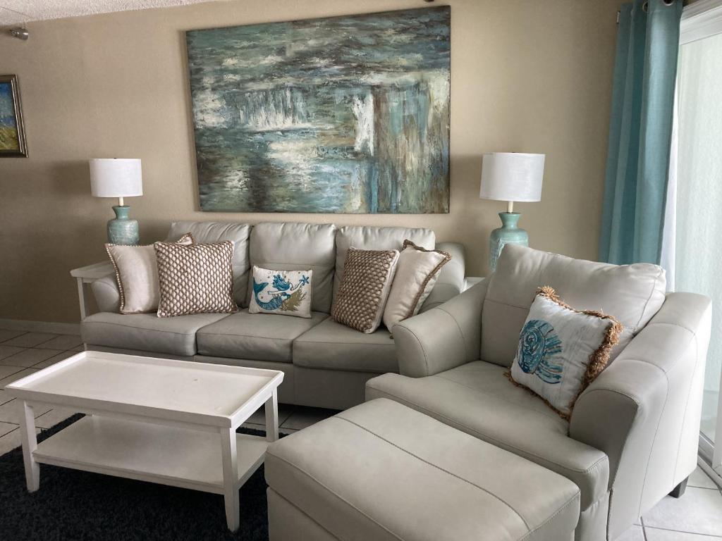 a living room with a couch and a table at Emerald Skye 36 in Orange Beach