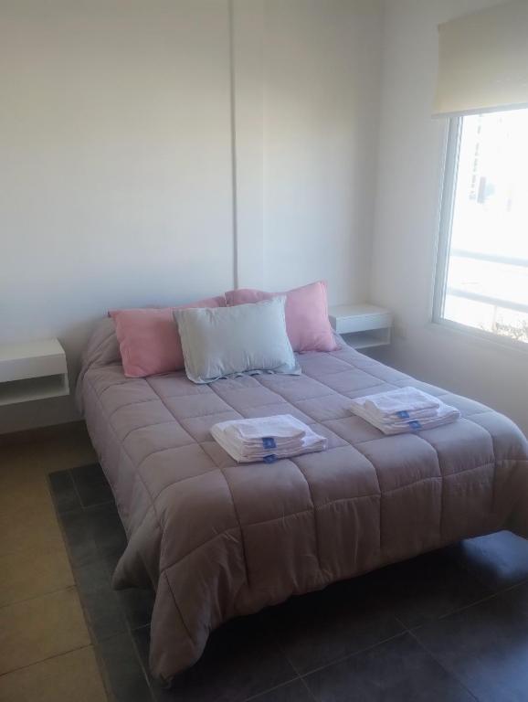 a large couch in a room with a window at Dpto Zapiola - 2 Ambientes 3er piso por escalera in Bahía Blanca