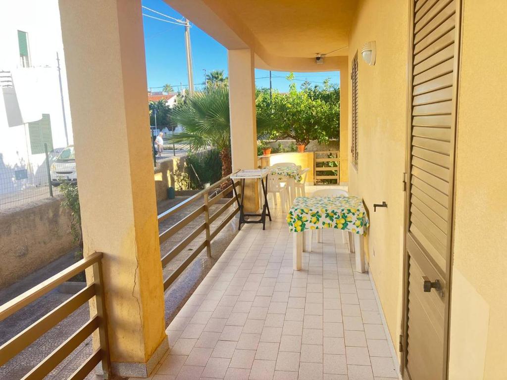 a balcony with a table and a chair on it at AleMar House in Marinella di Selinunte