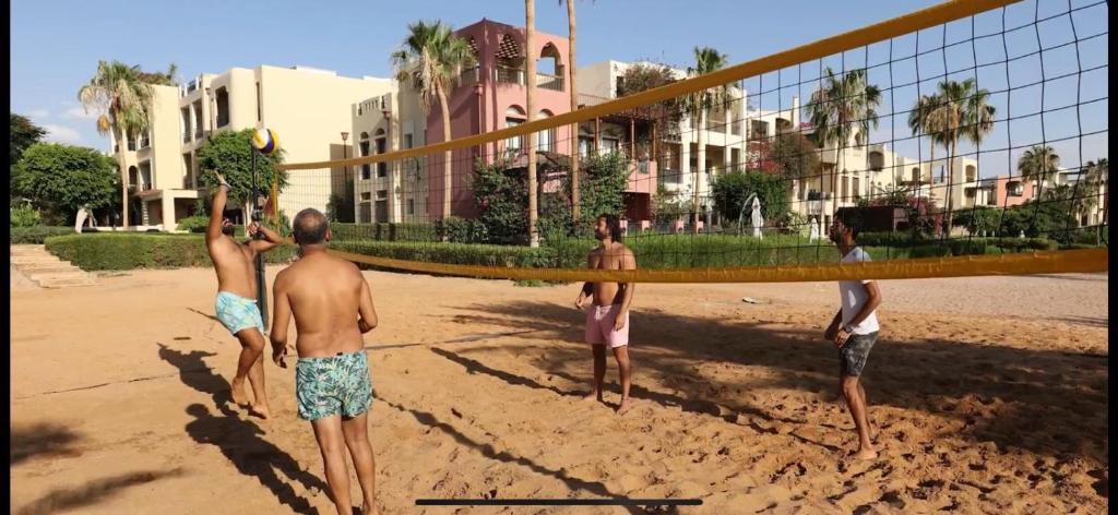 a group of men standing around a volleyball net at Private Apartment One bed room at Talabay -Independent Listing in Aqaba