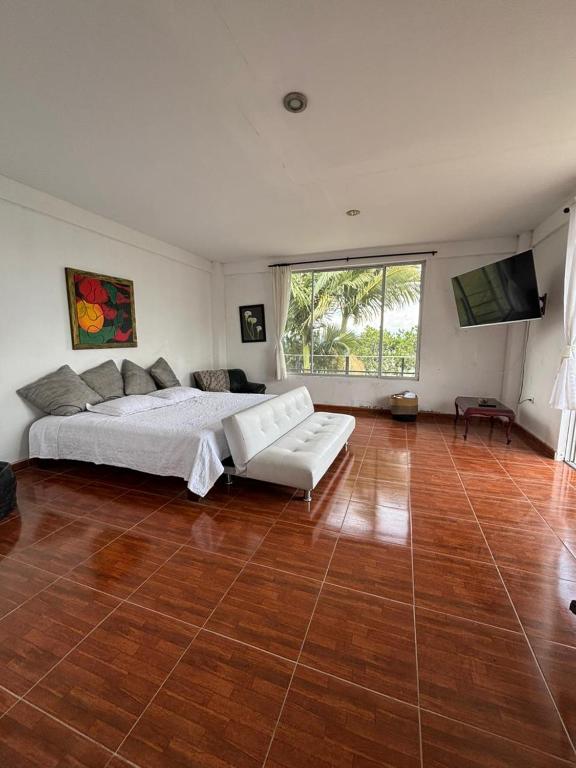 a large bedroom with a bed and a television at Hostal Santa Teresita in La Merced