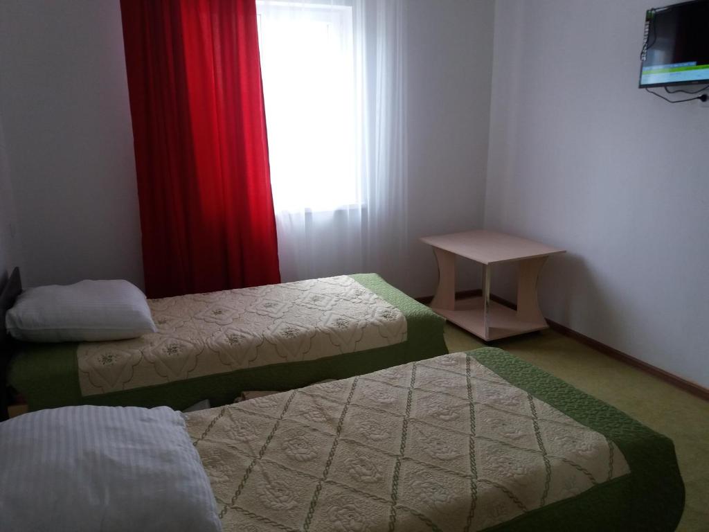 Postel nebo postele na pokoji v ubytování Guest House Arbat