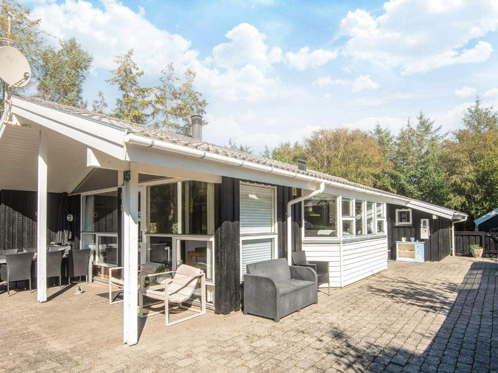 a house with a porch with a couch and chairs at Luxury Spa Retreat in Blavand - By Traum Ferienwohnungen in Blåvand