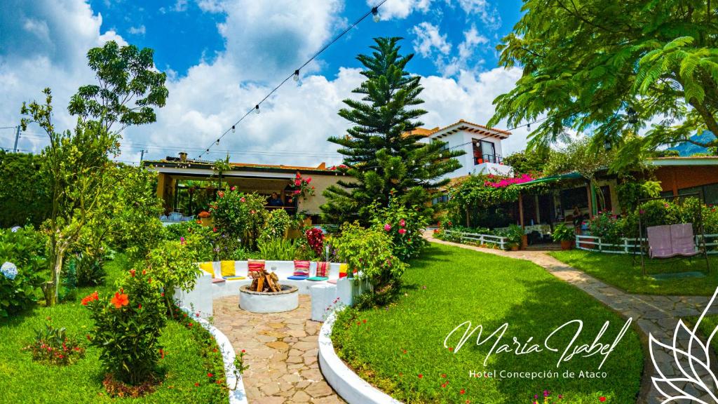 a house with a garden with a fountain in the yard at Hotel María Isabel Ataco in Concepción de Ataco