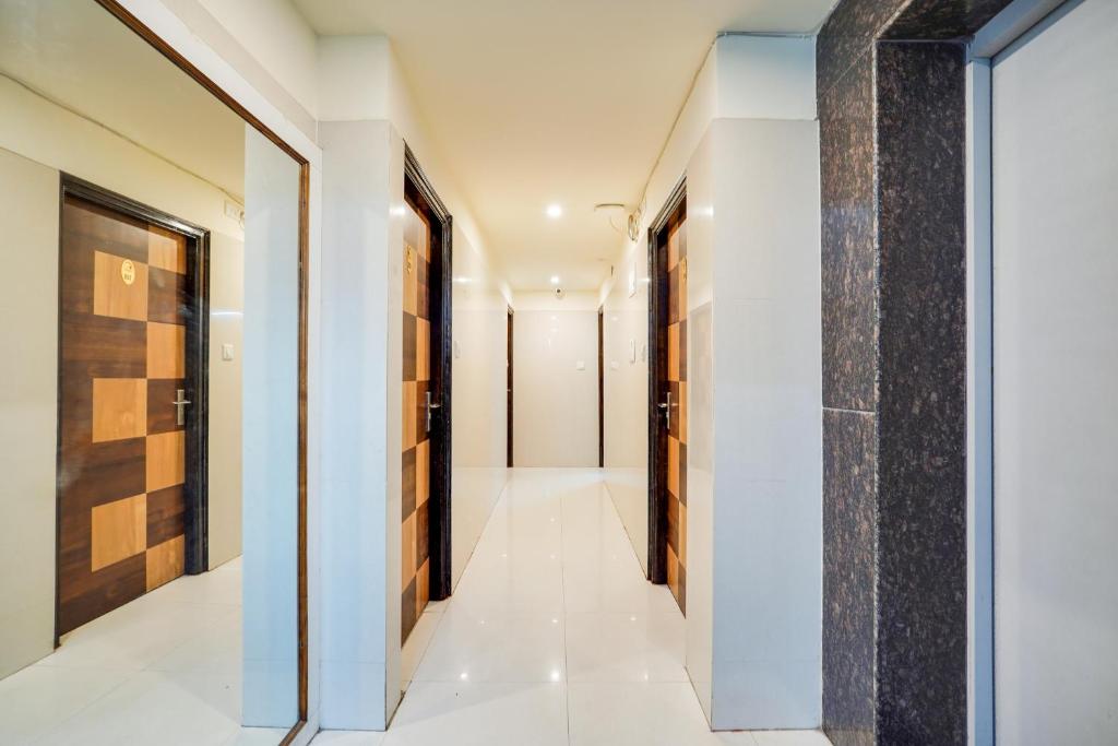 a hallway of a house with white walls and a pillar at Hotel O S Nandhi Residency in Bengaluru