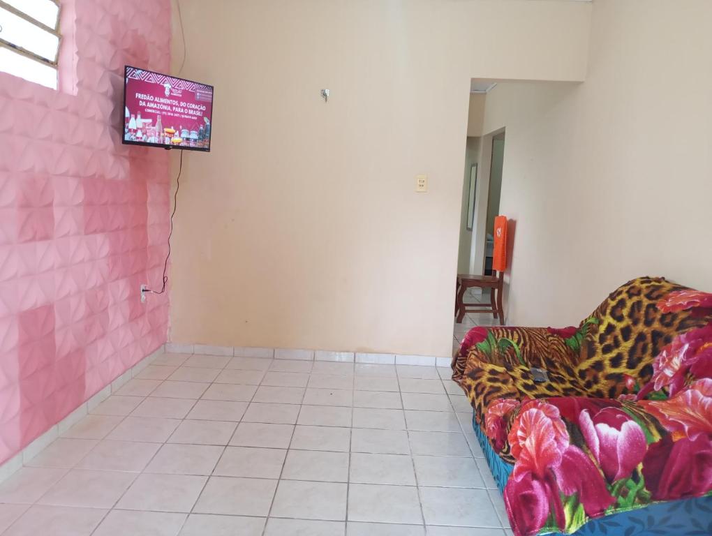 Una sala de estar con un sofá y un televisor. en Casa de Praia em Mosqueiro, en Belém