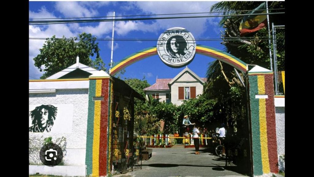 a arch in front of a house with a rainbow at A Caribbean Oasis 