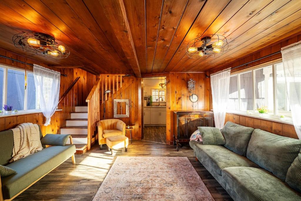 a living room with a couch and a fireplace at Cozy vibes, hot tub, EV charger, 1mi to beach in Westport