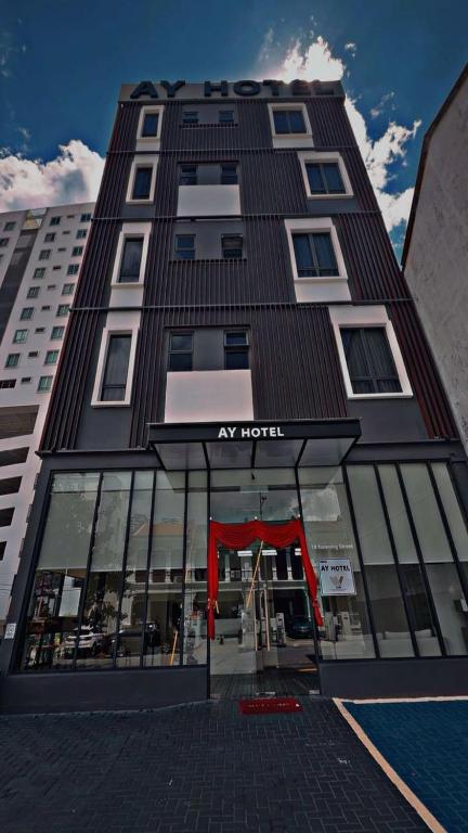 a tall building with a red door in front of it at Georgetown AY Hotel in George Town