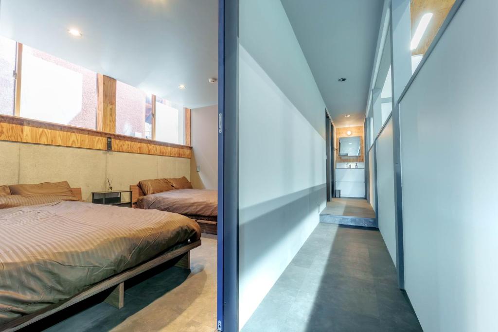 Postel nebo postele na pokoji v ubytování 天候に左右されない!室内温水プールと室内BBQが楽しめる---Casa CarpeDiem---