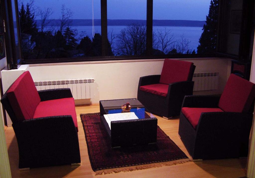 a living room with two chairs and a table at Apartment Alea in Portorož