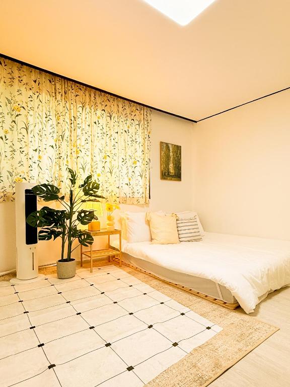 a bedroom with two beds and a potted plant at Sum Leisure Gocheok Dome 6 minutes Emotional 4-person two-room in Seoul