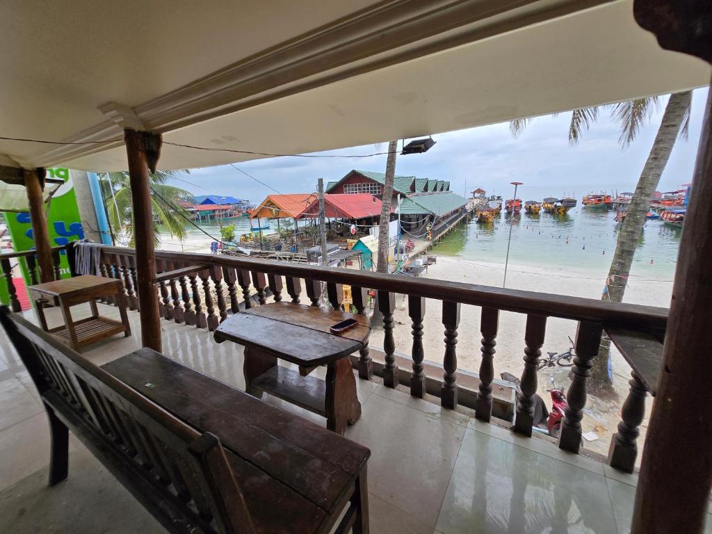 a balcony with a bench and a view of a beach at Family Guesthouse and Hostel in Koh Rong Island