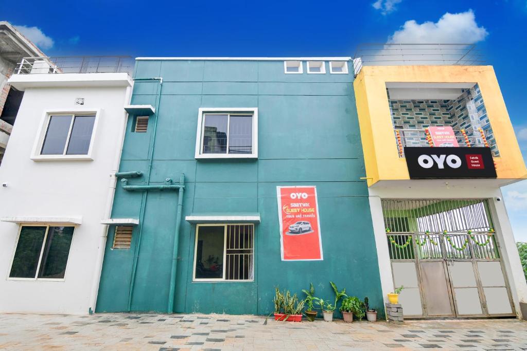 a blue and white building with a sign on it at Hotel O SATWIK GUEST HOUSE in Khandagiri