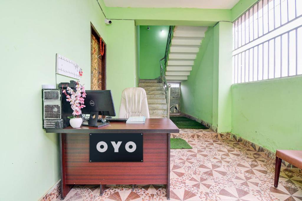 an office with a desk with an ovy sign on it at Hotel O SATWIK GUEST HOUSE in Khandagiri