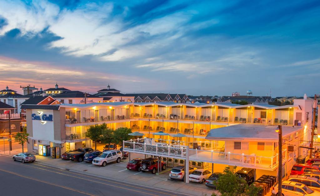 a large building with cars parked in a parking lot at Sea Gull Motel in Wildwood