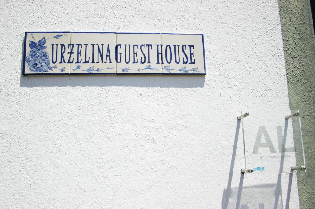 a sign on the side of a building at Urzelina GuestHouse in Urzelina