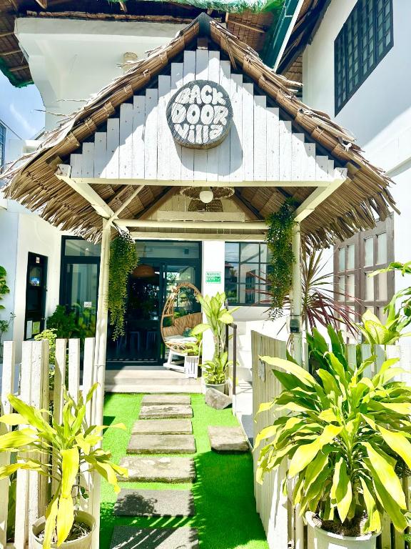 a house with a sign on the front of it at BACKDOOR VILLA in Baler