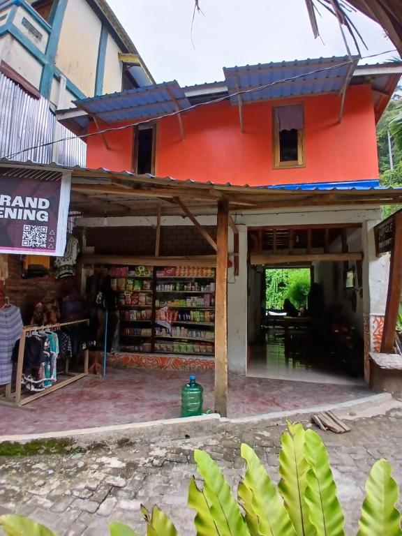 a store with a red building at Green View Homestay & Jungle Trekking in Bukit Lawang