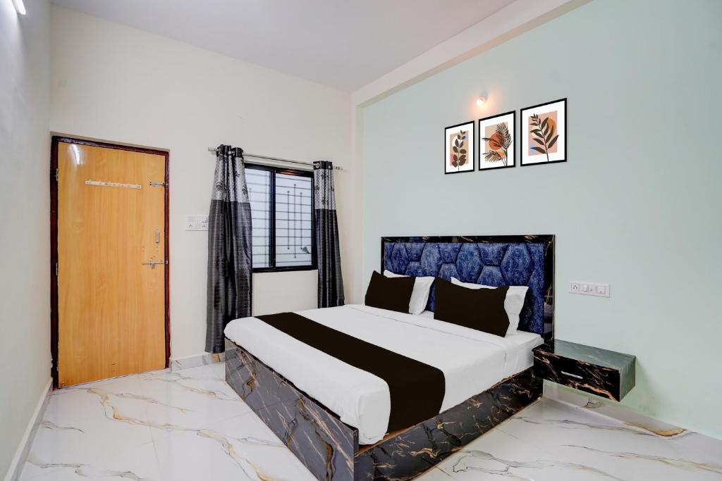 a bedroom with a large bed in a room at SPOT ON Hotel Royal Inn in Chandrapur