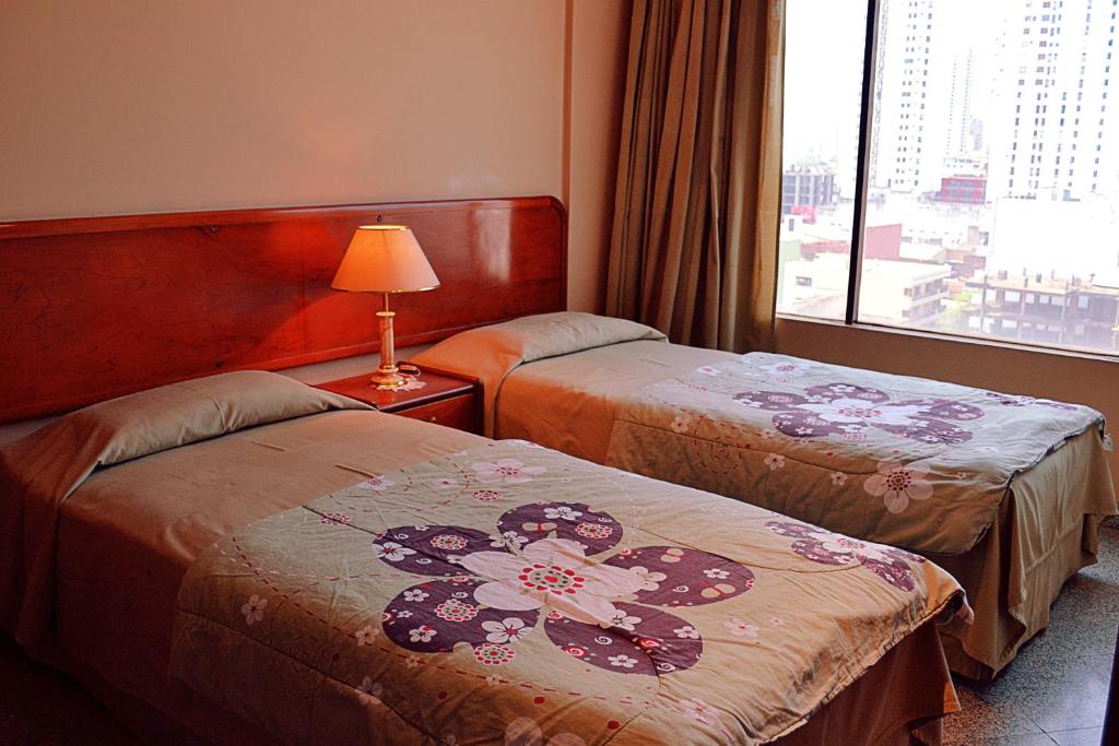 Letto o letti in una camera di Hotel Manduara