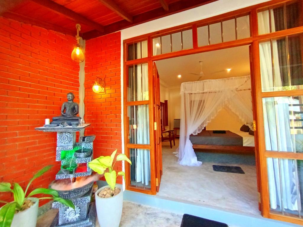 a room with a room with a bed and a window at Minuda Villa in Kamburugamuwa
