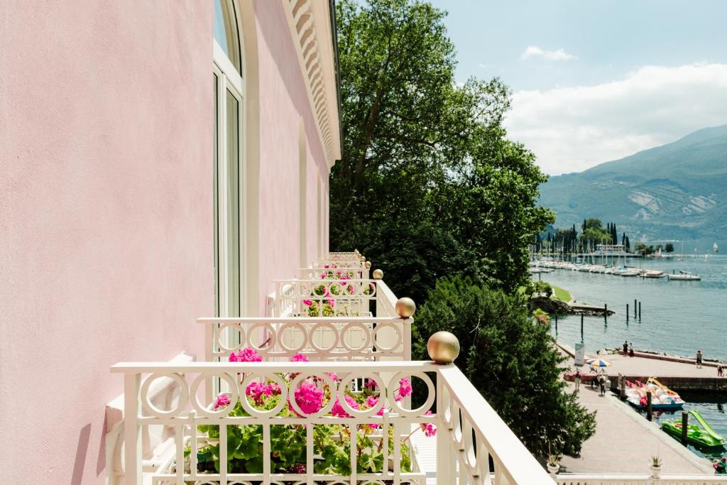 a balcony with pink flowers on a building at Bellavista Lakefront Apartments in Riva del Garda